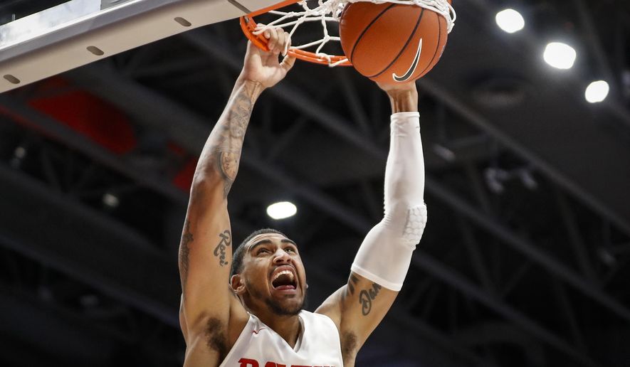 Dayton's Obi Toppin dunks during the first half of an NCAA college basketball game against Houston Baptist, Tuesday, Dec. 3, 2019, in Dayton, Ohio. (AP Photo/John Minchillo)