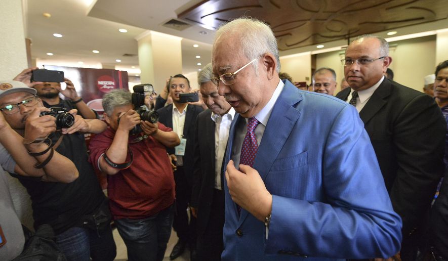 Former Malaysian Prime Minister Najib Razak, center, walks out from the courtroom at the court house in Kuala Lumpur, Malaysia for his corruption trial Tuesday, Dec. 3, 2019. Razak has started his defense Tuesday, Dec. 3, 2019, in his first corruption trial linked to the multibillion-dollar looting of the 1MDB state investment fund, that helped led to his downfall last year. (AP Photo)