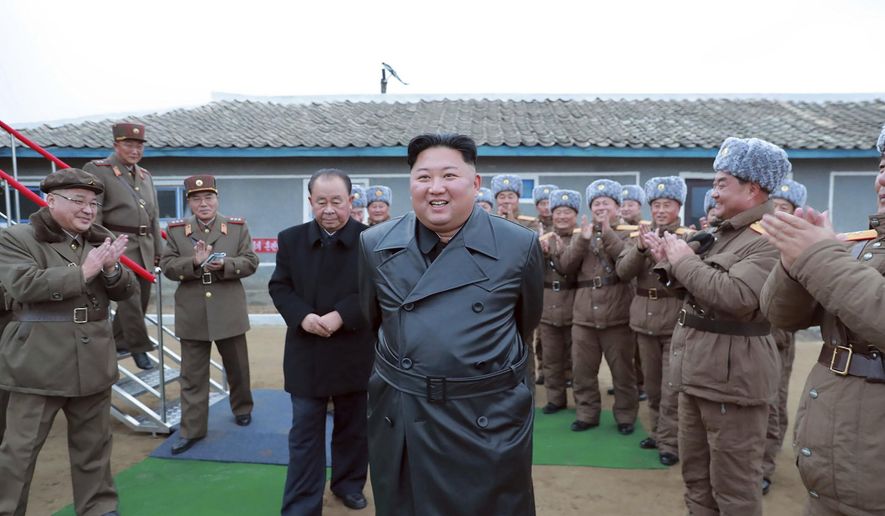 This undated file photo provided on Friday, Nov. 29, 2019, by the North Korean government, shows North Korean leader Kim Jong-un, center, surrounded by a military unit, reacts to what it claims as a test firing of its "super-large" multiple rocket launcher in North Korea. North Korea on Tuesday, Dec. 3, has repeated claims that the Trump administration is running out of time to salvage nuclear negotiations and says it's entirely up to the United States to choose what "Christmas gift" it gets from the North. (Korean Central News Agency/Korea News Service via AP, File)