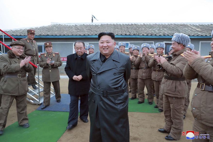 This undated file photo provided on Friday, Nov. 29, 2019, by the North Korean government, shows North Korean leader Kim Jong-un, center, surrounded by a military unit, reacts to what it claims as a test firing of its "super-large" multiple rocket launcher in North Korea. North Korea on Tuesday, Dec. 3, has repeated claims that the Trump administration is running out of time to salvage nuclear negotiations and says it's entirely up to the United States to choose what "Christmas gift" it gets from the North. (Korean Central News Agency/Korea News Service via AP, File)