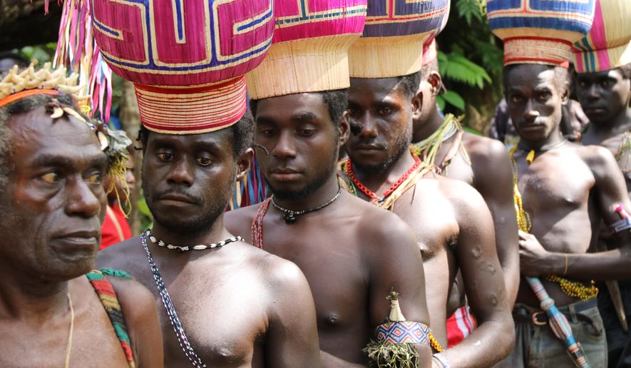 In this Nov. 29, 2019, photo, the Upe members wait to vote in the Bougainville referendum in Teau, Bougainville, Papua New Guinea. All across the Pacific region of Bougainville, people have been voting in a historic referendum to decide if they want to become the world’s newest nation by gaining independence from Papua New Guinea. (Jeremy Miller, Bougainville Referendum Commission via AP)
