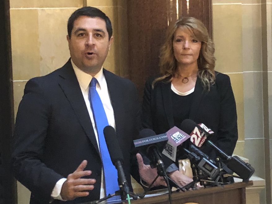 Wisconsin Attorney General Josh Kaul, left, and rape survivor Jacqueline Jaske, call on Republicans to pass a bill designed to prevent the backlog of kits containing evidence from sexual assaults at a Capitol news conference on Tuesday, Dec. 23, 2019, in Madison, Wis. The Senate passed the bill in October, but it's gone nowhere in the Assembly. (AP Photo/Scott Bauer)