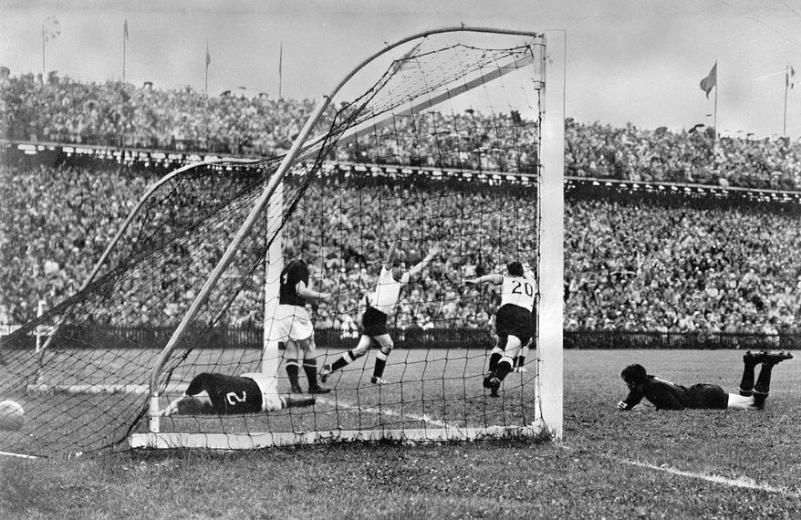 FILE - In this July 4, 1954 file photo, West Germany's Helmut Rahn, center with arms raised, celebrates after equalising in the World Cup soccer final match against Hungary, at Wankdorf Stadium, in Bern, Switzerland. The stadium in Switzerland that staged the 1954 World Cup final is getting its original name back. Swiss champion Young Boys says a new sponsorship deal sees the historic Wankdorf Stadium name restored. It was rebranded Stade de Suisse after being rebuilt for Euro 2008. (AP Photo, File)