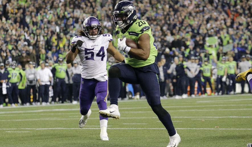 Seattle Seahawks&#x27; Rashaad Penny high steps into the end zone for a touchdown against the Minnesota Vikings during the second half of an NFL football game, Monday, Dec. 2, 2019, in Seattle. (AP Photo/John Froschauer)