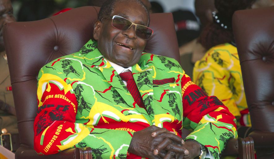 FILE - In this Friday, June, 2, 2017 file photo Zimbabwean President Robert Mugabe smiles during a youth rally in Marondera, east of Harare. The wealth of Zimbabwe’s former longtime president Robert Mugabe was long a mystery. Now the first official list of assets to be made public says he left behind $10 million and several houses when he died in September, 2019. Some in Zimbabwe view that estate as far too modest for Mugabe, who ruled for 37 years and was accused by critics of accumulating vast riches and presiding over grand corruption. (AP Photo/Tsvangirayi Mukwazhi, File)