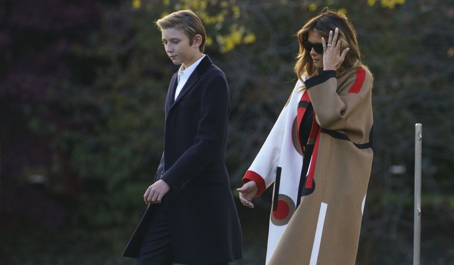 First lady Melania Trump and her son Barron Trump, walk to board Marine One at the White House in Washington, Tuesday, Nov. 20, 2018, for the short trip to Andrews Air Force Base en route to Palm Beach International Airport, in West Palm Beach, Fla., and onto Mar-a-Lago. (AP Photo/Carolyn Kaster) ** FILE **
