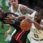 Boston Celtics guard Kemba Walker (8) steals the ball from Miami Heat center Bam Adebayo, left, during the first half of an NBA basketball game in Boston, Wednesday, Dec. 4, 2019. (AP Photo/Charles Krupa)