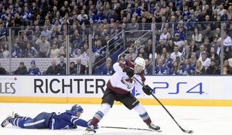 Colorado Avalanche right wing Valeri Nichushkin (13) gets a breakaway as Toronto Maple Leafs defenseman Morgan Rielly (44) dives to stop him during the third period of an NHL hockey game, Wednesday, Dec. 4, 2019 in Toronto. (Nathan Denette/The Canadian Press via AP)