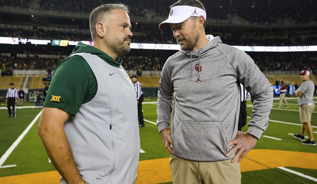 FILE - In this Nov. 16, 2019, file photo, Baylor head coach Matt Rhule, left, and Oklahoma head coach Lincoln Riley talk at midfield prior to an NCAA college football game in Waco, Texas. Rhule and Riley took over their teams under drastically different circumstances. Now they will coach against each other in the Big 12 championship game. (AP Photo/Ray Carlin, File)