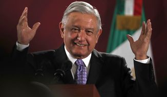 Mexican President Andres Manuel Lopez Obrador smiles during his daily morning press conference at the National Palace in Mexico City, Wednesday, Nov. 13, 2019. Mexico has granted asylum to Bolivia&#39;s former President Evo Morales, who resigned on Nov. 10th under mounting pressure from the military and the public after his re-election victory triggered weeks of fraud allegations and deadly protests. (AP Photo/Marco Ugarte)
