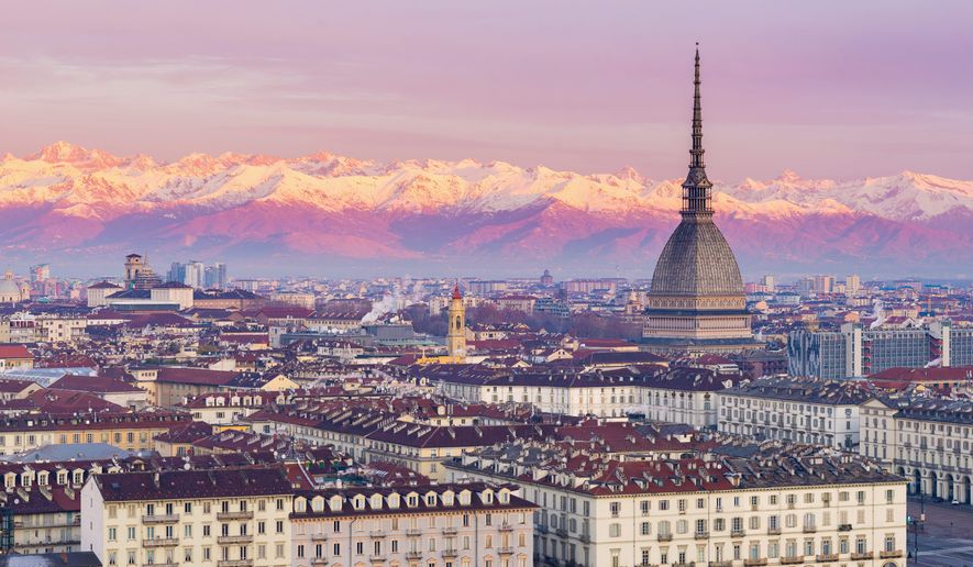 Turin, Italy at sunrise with the Mole Antonelliana towering over the city.