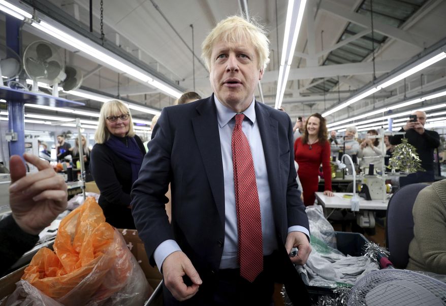 Britain&#39;s Prime Minister Boris Johnson visits John Smedley Mill in Matlock, England, Thursday, Dec. 5, 2019. Britain is holding a general election a week from now and fractures are emerging within jittery political parties unsure how a volatile electorate will judge them. Conservative Prime Minister Boris Johnson and main opposition Labour Party leader Jeremy Corbyn both faced criticism of their moral character. (Hannah McKay/Pool Photo via AP)