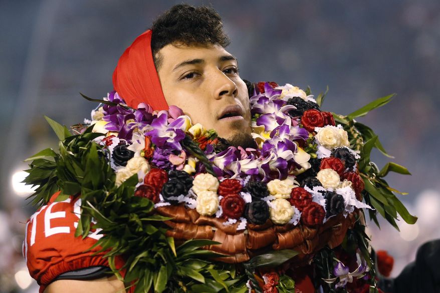Utah defensive end Bradlee Anae walks on the field before the team's NCAA college football game against Colorado on Saturday, Nov. 30, 2019, in Salt Lake City. (AP Photo/Rick Bowmer)
