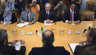 FILE - In this Aug. 14, 2017 file photo, Libyan militia commander General Khalifa Hifter, top center, listens to Russian Foreign Minister Sergei Lavrov, bottom center, during their meeting in Moscow, Russia. Officials in Libya’s U.N.-backed administration say they plan to present evidence to Moscow of Russian mercenaries fighting alongside their adversary in their country’s war. Libyan officials say up to 800 fighters from the Russian private security contractor Wagner Group have joined the forces of Hifter, the commander of forces battling for months trying to capture Libya’s capital, Tripoli. (AP Photo/Ivan Sekretarev, File)