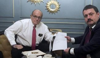 In this handout photo provided by Adriii Derkach&#x27;s press office, Rudy Giuliani, an attorney for U.S President Donald Trump, left, meets with Ukrainian lawmaker Adriii Derkach in Kyiv, Ukraine, Thursday, Dec. 5, 2019. A Ukrainian lawmaker says he has met up with Rudy Giuliani, President Donald Trump’s personal attorney, in Kyiv to discuss an anti-corruption project. Derkach, who has previously accused the son of former Vice President Joe Biden of embezzling money from a gas company in Ukraine, posted photos of Thursday’s meeting on his Facebook page. (Adriii Derkach&#x27;s press office via AP)