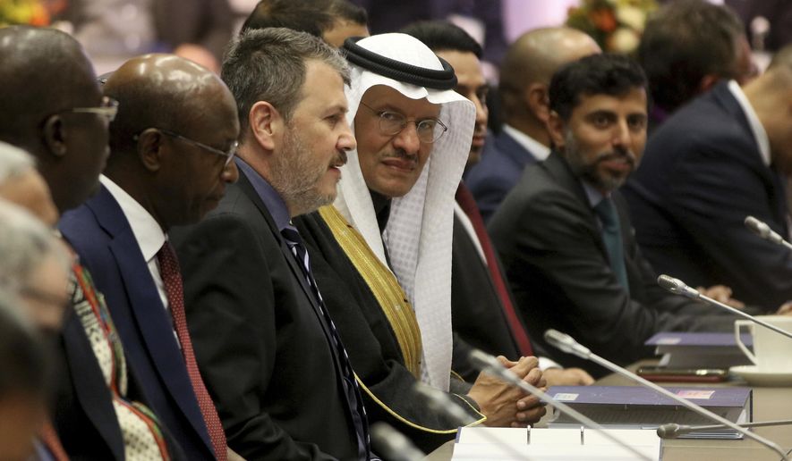 Prince Abdulaziz bin Salman Al-Saud, center, Minister of Energy of Saudi Arabia looks prior to the start of a meeting of the Organization of the Petroleum Exporting Countries, OPEC, at their headquarters in Vienna, Austria, Thursday, Dec. 5, 2019. (AP Photo/Ronald Zak)