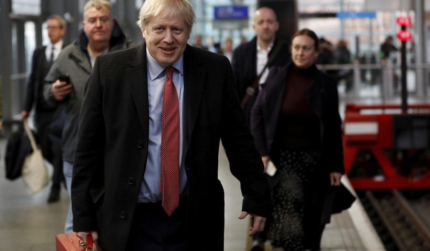 Britain's Prime Minister Boris Johnson arrives on the platform to board a train in London, Friday Dec. 6, 2019, on the campaign trail ahead of the general election on Dec. 12. Johnson pushed for the December vote, which is taking place more than two years early, in hopes of winning a majority and breaking Britain's political impasse over Brexit. (Peter Nicholls/Pool via AP)
