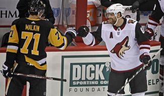 Two-time Stanley Cup Champion with the Pittsburgh Penguins, Arizona Coyotes&#39; Phil Kessel, right, is welcomed back by former linemate Pittsburgh Penguins&#39; Evgeni Malkin (71) following a tribute to him during a timeout in the first period of an NHL hockey game in Pittsburgh, Friday, Dec. 6, 2019. (AP Photo/Gene J. Puskar)