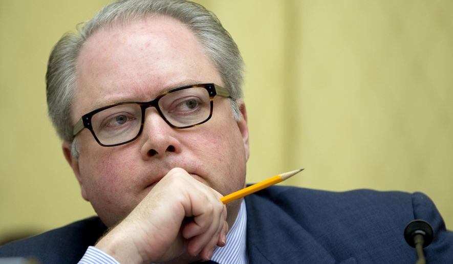 FILE - In this May 8, 2014 file photo, Rep. George Holding, R-N.C., listens to testimony during the House Judiciary Subcommittee on Regulatory Reform, Commercial, and Antitrust Law oversight hearing on "Competition in the Video and Broadband Markets: Proposed Merger of Comcast and Time Warner Cable", on Capitol Hill in Washington.  Holding won't run for reelection, announcing his decision on Friday, Dec. 6, 2019. Holding represents the 2nd Congressional District, which was dramatically altered by the state legislature a few weeks ago because state judges ruled it was likely the previous map was tainted with extreme partisan bias favoring the GOP.  (AP Photo/Carolyn Kaster)