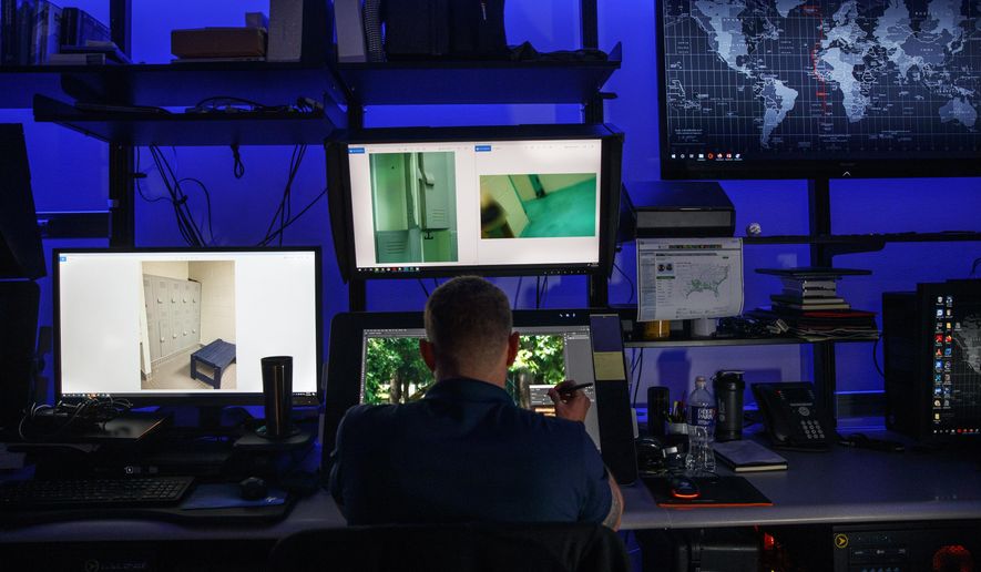 A computer forensic analyst reviews a case inside the Victim Identification Lab, part of Homeland Security's Child Exploitation Investigations Unit, in Fairfax, Va., Friday, Nov. 22, 2019. (AP Photo/Jacquelyn Martin) **FILE**