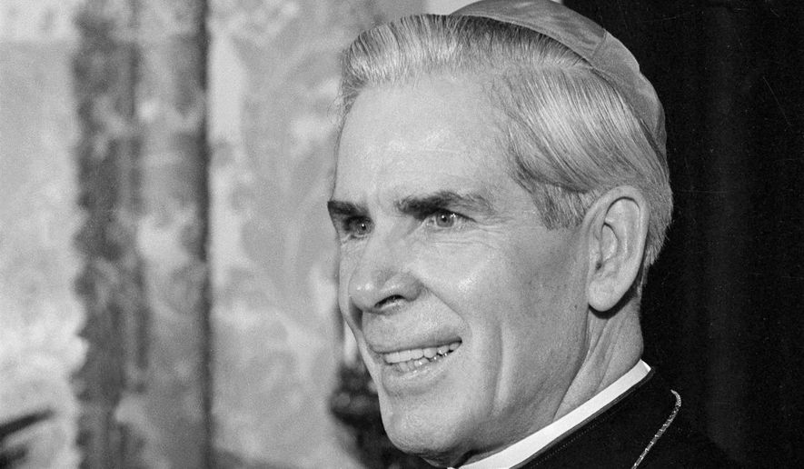 FILE - This Oct. 26, 2019 file photo shows Bishop Fulton J. Sheen at his office at the Propagation of Faith in New York. The Catholic diocese of Rochester, N.Y., confirms it made the request for further investigations that prompted the Vatican to take the rare step of delaying Archbishop Fulton Sheen’s journey to sainthood. Pope Francis said last month that Sheen’s beatification had been approved and would take place on Dec. 21, 2019 in Peoria, where he was ordained in 1919. The Peoria diocese announced Tuesday, Dec. 3 that the Vatican had postponed the ceremony indefinitely. (AP Photo/Eddie Adams)