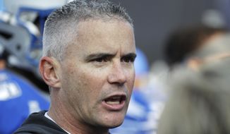 Memphis head coach Mike Norvell watches as players warm up before the start of an NCAA college football game against Cincinnati for the American Athletic Conference championship Saturday, Dec. 7, 2019, in Memphis, Tenn. (AP Photo/Mark Humphrey)