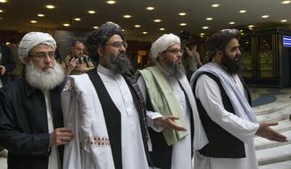 In this May 28, 2019, photo, Mullah Abdul Ghani Baradar, the Taliban group&#39;s top political leader, second left, arrives with other members of the Taliban delegation for talks in Moscow, Russia. U.S. peace envoy Zalmay Khalilzad held on Saturday, Dec. 7, 2019, the first official talks with Afghanistan&#39;s Taliban since last September when President Donald Trump declared a near-certain peace deal with the insurgents dead. (AP Photo/Alexander Zemlianichenko) **FILE**