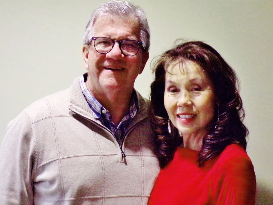 This Nov. 20, 2019 photo shows Doug and Julie Henning at Pearl S. Buck Institute in Hilltown, Pa. Julie Henning has told her life story at churches, schools, civic groups and conferences, sharing about coming from poverty in her native Korea to Bucks County and being raised as Nobel and Pulitzer prize winning author Pearl S. Buck's daughter. Now, Henning has written about it in a new memoir, "A Rose in a Ditch." (Bob Keeler/The News-Herald via AP)