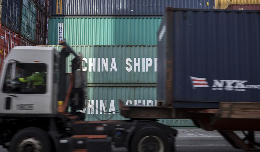 In this Thursday, July, 5, 2018, photo, a jockey truck passes a stack of 40-foot China Shipping containers at the Port of Savannah in Savannah, Ga. (AP Photo/Stephen B. Morton) **FILE**