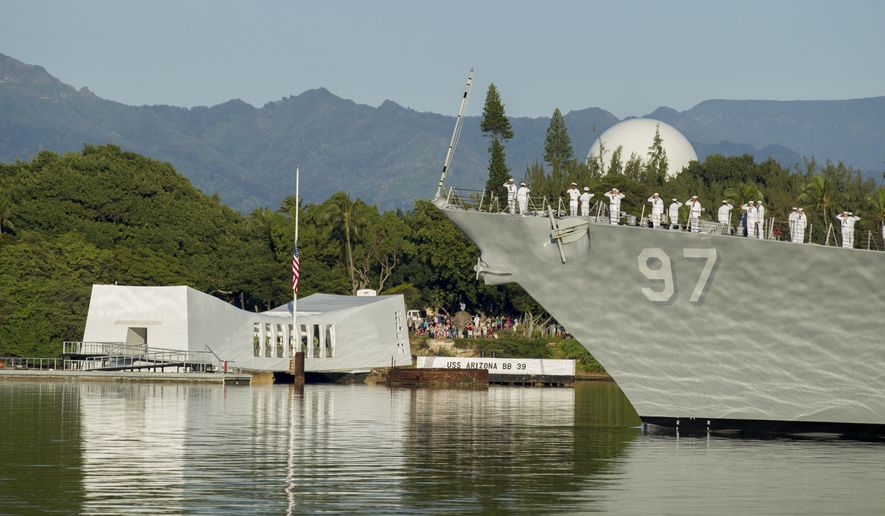 In this Dec. 7, 2016, file photo, sailors on the USS Halsey salute while passing by the USS Arizona Memorial during a moment of silence at Pearl Harbor, Hawaii. (AP Photo/Eugene Tanner, File)