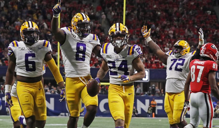 LSU cornerback Derek Stingley Jr. (24) celebrates with teammates his interception against Georgia during the second half of the Southeastern Conference championship NCAA college football game, Saturday, Dec. 7, 2019, in Atlanta. (AP Photo/John Bazemore)