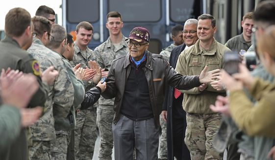 Retired U.S. Air Force Col. Charles McGee (center), a decorated veteran of three wars, receives a congratulatory a send off after visiting with 436 Aerial Port Squadron personnel at Dover Air Force Base to help celebrate his 100th birthday in Dover, Delaware, Friday, Dec. 6, 2019. McGee&#39;s birthday is Dec. 7. (AP Photo/David Tulis)