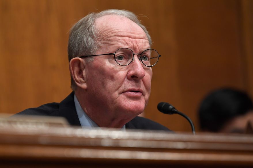 Sen. Lamar Alexander, Tennessee Republican, called the deal on the surprise medical bills and raising tobacco purchasing age "a very good Christmas present" should Congress choose to unwrap it now. (Associated Press)