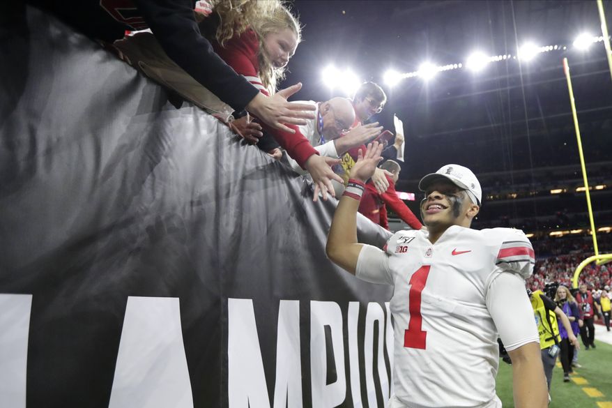 Ohio State quarterback Justin Fields (1) celebrates with fans following the team's Big Ten championship NCAA college football game against Wisconsin, early Sunday, Dec. 8, 2019, in Indianapolis. Ohio State won 34-21. (AP Photo/Michael Conroy)