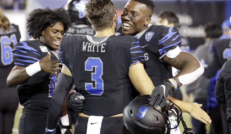 Memphis quarterback Brady White (3) hugs running back Patrick Taylor Jr. in the final minutes of the fourth quarter of an NCAA college football game against Cincinnati, Friday, Nov. 29, 2019, in Memphis, Tenn. (AP Photo/Mark Humphrey)