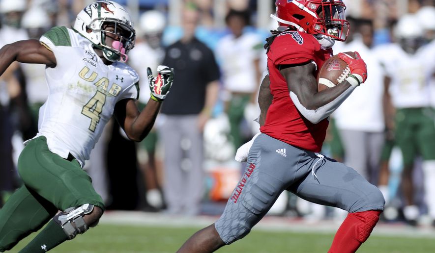 Florida Atlantic's Deangelo Antoine runs to the end zone for a touchdown as UAB'S Starling Thomas V chases during an NCAA college football game against UAB for the Conference USA championship, Saturday, Dec. 7, 2019, in Boca Raton, Fla. (Mike Stocker/South Florida Sun-Sentinel via AP)