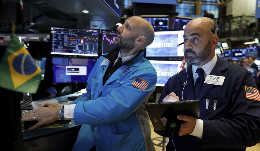 FILE - In this Nov. 15, 2019, file photo specialist Meric Greenbaum, left, and trader Fred DeMarco work on the floor of the New York Stock Exchange. The U.S. stock market opens at 9:30 a.m. EST on Friday, Dec. 6. (AP Photo/Richard Drew, File)