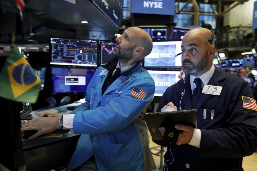 FILE - In this Nov. 15, 2019, file photo specialist Meric Greenbaum, left, and trader Fred DeMarco work on the floor of the New York Stock Exchange. The U.S. stock market opens at 9:30 a.m. EST on Friday, Dec. 6. (AP Photo/Richard Drew, File)