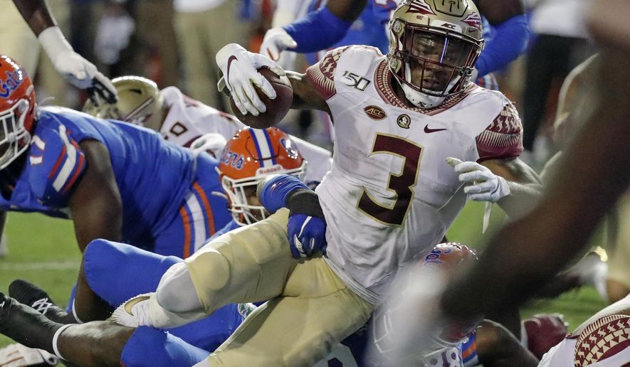Florida State running back Cam Akers (3) runs for a first down against Florida on fourth=and-1 during the first half of an NCAA college football game, Saturday, Nov. 30, 2019, in Gainesville, Fla. (AP Photo/John Raoux)