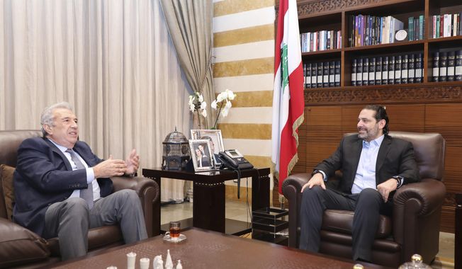 In this photo released by the Lebanese Government, Lebanon&#x27;s outgoing Prime Minister Saad Hariri, right, meets with Samir Khatib, the head of a major contracting and construction and once considered a favorite candidate for the post of Prime Minister, in Beirut, Lebanon, Sunday, Dec. 8, 2019. (Dalati Nohra via AP)
