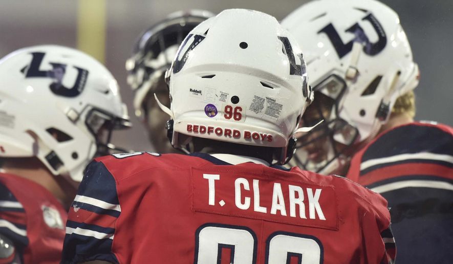 Liberty defensive end TreShaun Clark sports a Bedford Boys helmet during an NCAA college football game against New Mexico State at Williams Stadium at Liberty University in Lynchburg, Va., Saturday, Nov. 30, 2019. (Taylor Irby/The News & Advance via AP)