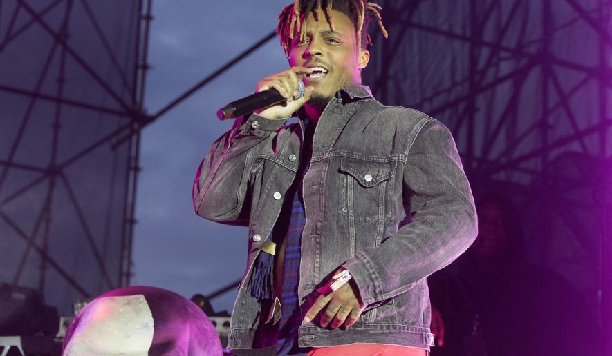 FILE - In this May 15, 2019 file photo, Juice WRLD performs in concert during his "Death Race for Love Tour" at The Skyline Stage at The Mann Center for the Performing Arts in Philadelphia. The Chicago-area rapper, whose real name is Jarad A. Higgins, was pronounced dead Sunday, Dec. 8 after a "medical emergency'' at Chicago's Midway International Airport, according to authorities. Chicago police said they're conducting a death investigation. (Photo by Owen Sweeney/Invision/AP, File)