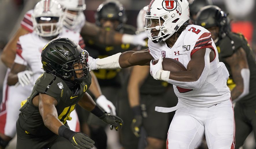 Utah running back Zack Moss (2) stiff-arms Oregon cornerback Thomas Graham Jr. (4) during the first half of the Pac-12 Conference championship NCAA college football game in Santa Clara, Calif., Friday, Dec. 6, 2018. (AP Photo/Tony Avelar)
