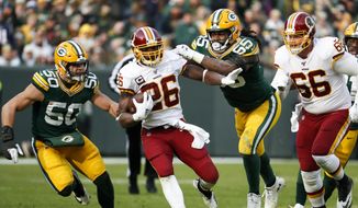 Washington Redskins&#39; Adrian Peterson runs during the first half of an NFL football game against the Green Bay Packers Sunday, Dec. 8, 2019, in Green Bay, Wis. (AP Photo/Matt Ludtke)  **FILE**