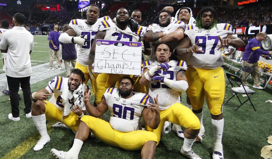 LSU players celebrate after the Southeastern Conference championship NCAA college football game against Georgia, Saturday, Dec. 7, 2019, in Atlanta. LSU won 37-10. (AP Photo/John Bazemore)