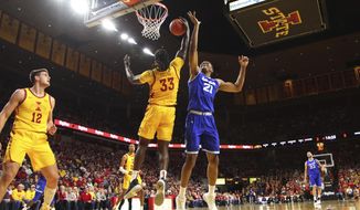 Iowa State forward Solomon Young, center, pulls down a rebound in front of Seton Hall center Ike Obiagu, right, during the first half of an NCAA college basketball game, Sunday, Dec. 8, 2019, in Ames, Iowa. (AP Photo/Matthew Putney)