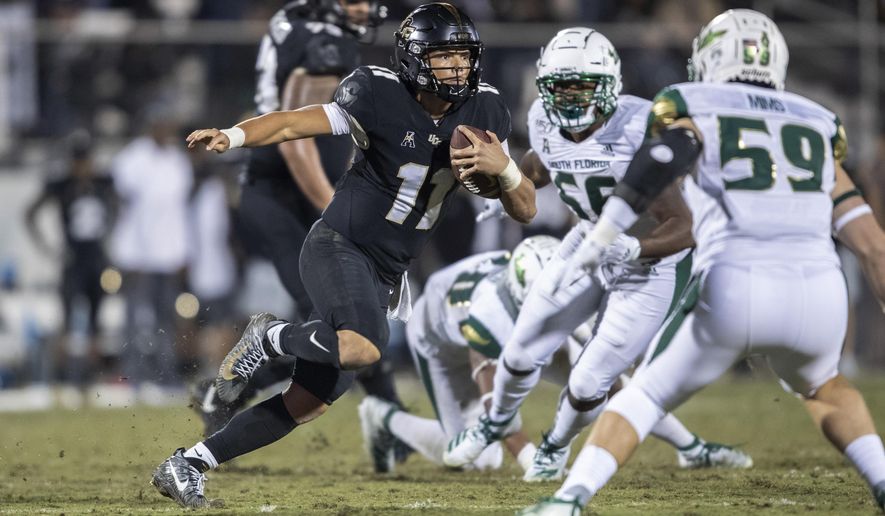Central Florida quarterback Dillon Gabriel (11) sprints away from the South Florida defense during the second half of an NCAA college football game Friday, Nov. 29, 2019, in Orlando, Fla. (AP Photo/Willie J. Allen Jr.)