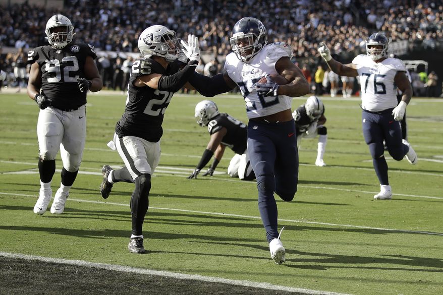 Tennessee Titans running back Derrick Henry (22) scores past Oakland Raiders free safety Erik Harris (25) during the first half of an NFL football game in Oakland, Calif., Sunday, Dec. 8, 2019. (AP Photo/Ben Margot)
