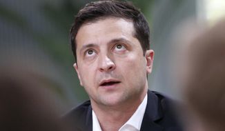 FILE In this file photo taken on Thursday, Oct. 10, 2019, Ukrainian President Volodymyr Zelenskiy speaks during talks with journalists in Kyiv, Ukraine. Ukraine&#39;s president sits down Monday, Dec. 9, 2019 for peace talks in Paris with Russian President Vladimir Putin in their first face-to-face meeting, and the stakes could not be higher. More than five years of fighting in eastern Ukraine between government troops and Moscow-backed separatists has killed more than 14,000 people, and a cease-fire has remained elusive. (AP Photo/Efrem Lukatsky, File)