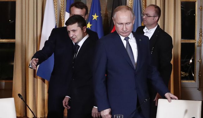 Russian President Vladimir Putin, right, and Ukrainian President Volodymyr Zelensky arrive for a working session at the Elysee Palace Monday, Dec. 9, 2019, in Paris. Russian President Vladimir Putin and Ukraine&#x27;s president are meeting for the first time at a summit in Paris to find a way to end the five years of fighting in eastern Ukraine. (Ian Langsdon/Pool via AP)